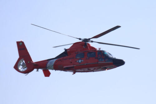 Coast Guard helicopter over the beach